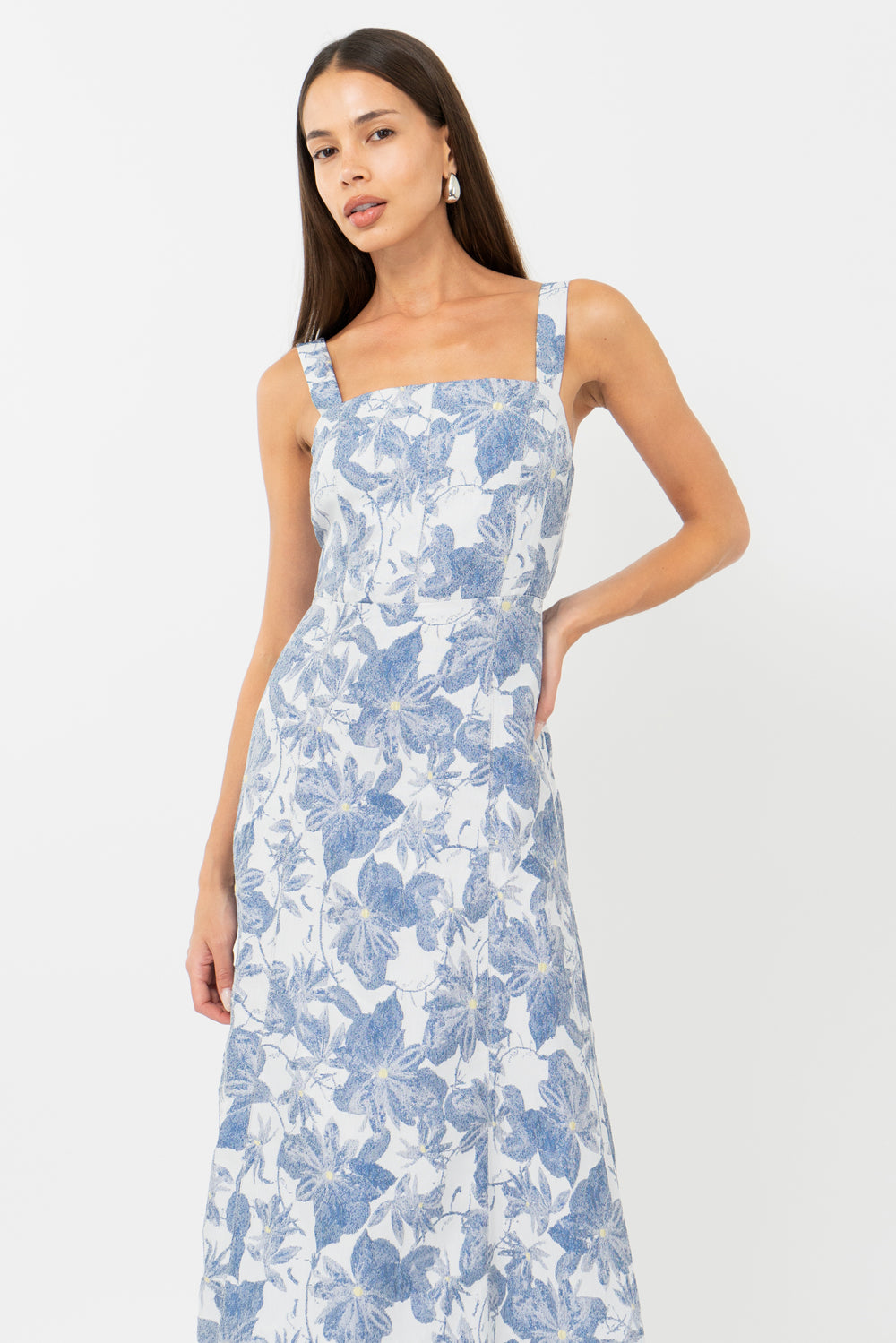 Blue and white floral wedding guest dress and graduation dress front studio view with hand on hip closeup 